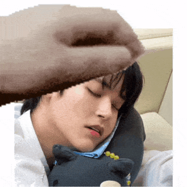 a pixelated image of a man sleeping with a stuffed animal on his chest