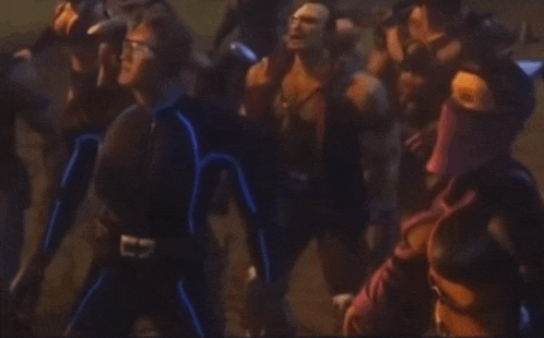 a blurry picture of a group of people fighting each other in a dark room .