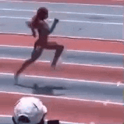 a person is running on a track with a baton .