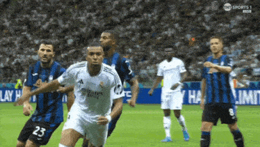 soccer players on a field with one wearing a number 23 jersey