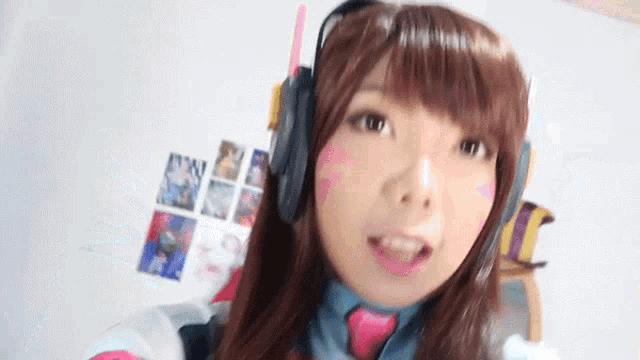 a woman wearing a wig and headphones is looking at the camera