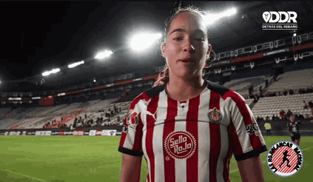 a woman wearing a red and white striped shirt with the word sello roja on it