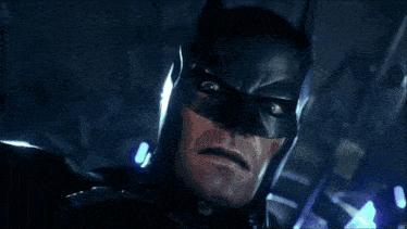 a close up of batman 's face in a dark room