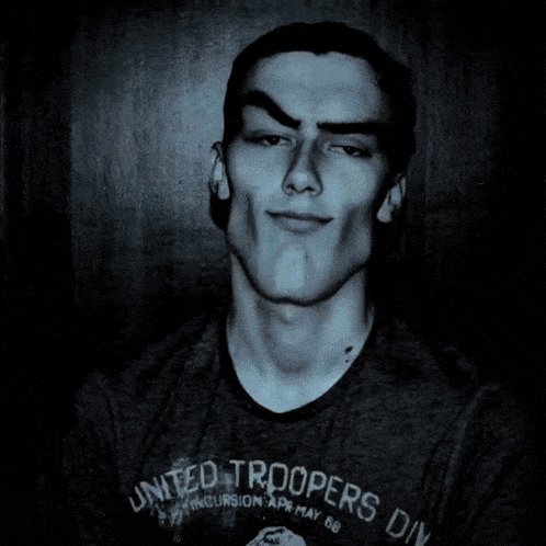 a young man is wearing a united troopers division t-shirt