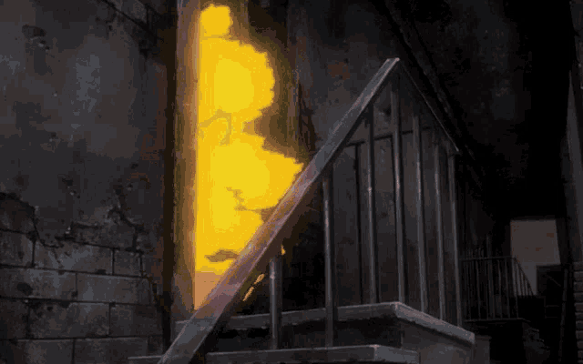 a staircase with a bright yellow light coming down it