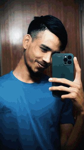 a man in a blue shirt is taking a picture of himself with his phone