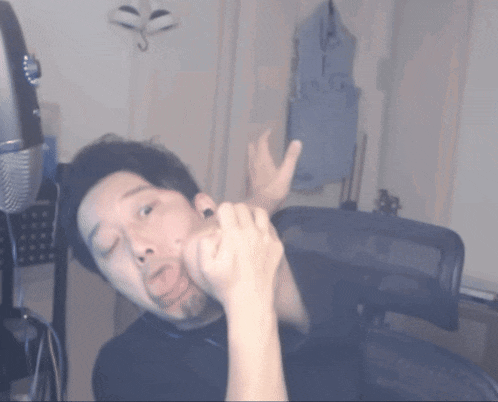 a blurry picture of a man making a face with his eyes closed