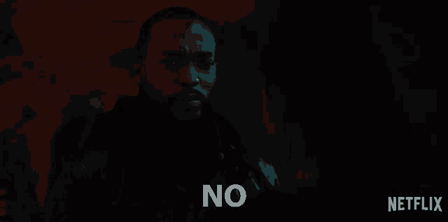 a man in a dark room says " no "
