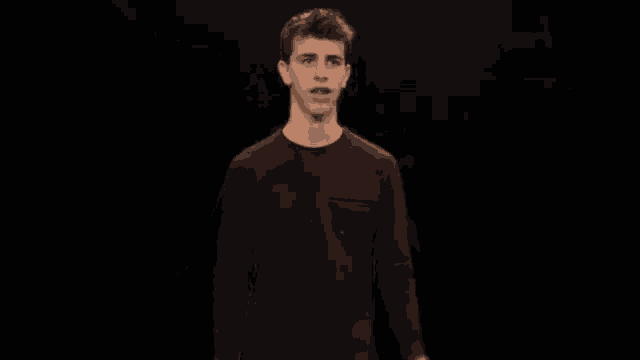 a young man wearing a maroon sweater with a pocket on the front