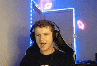 a young man wearing headphones is sitting in a gaming chair in a room .