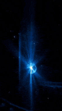 a blue light is shining on a sphere with the letter x on it