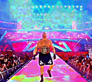 a wrestler with a belt that says w on it walks down a ramp