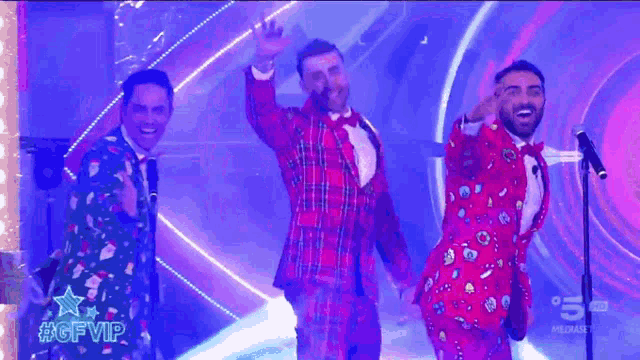 a group of men in red suits and bow ties are standing on a stage with a sign that says #gfvip