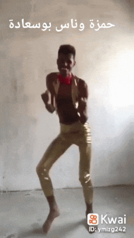a man in gold pants is dancing in a room with a kwai id