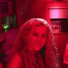 a woman in a red room with a closed sign on the wall