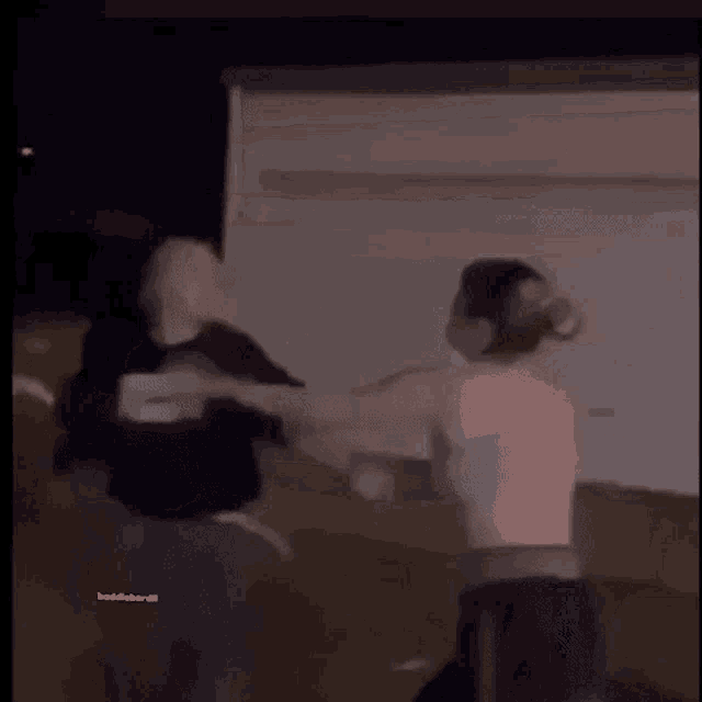 a blurry picture of a person standing in front of a white board with the words baddiebandit on the bottom