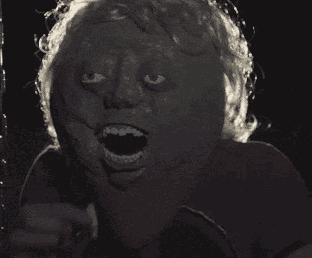 a close up of a person 's face with a strange look on their face