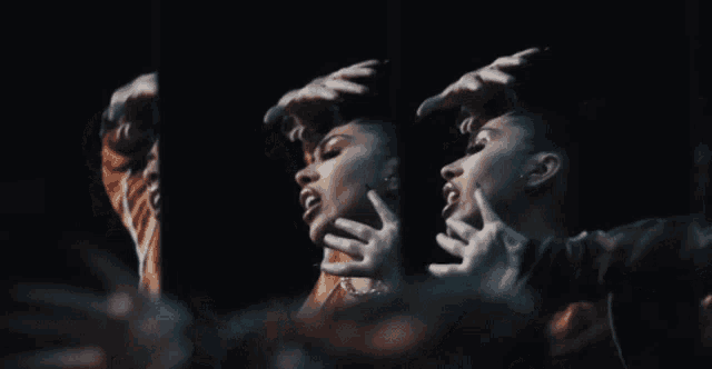 a woman 's face is reflected in a mirror in a dark room