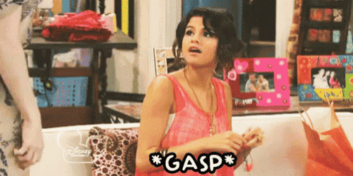 a woman sitting on a couch with the word gasp written on it