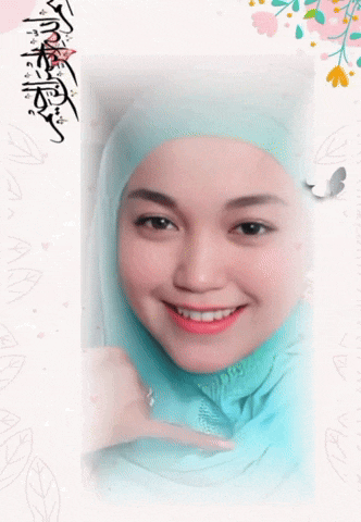 a woman wearing a blue hijab is smiling and pointing