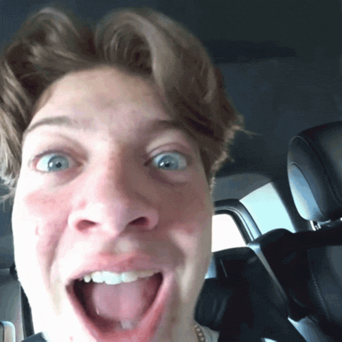 a close up of a man 's face with his tongue out