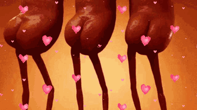 a bunch of hearts are flying around a person 's buttocks