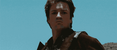 a pixelated image of a person 's face with a blue sky behind them
