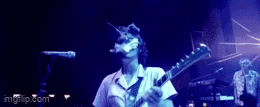 a man playing drums in front of a microphone with imgflip.com on the bottom right