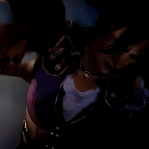 a close up of a person 's torso with a purple and brown jacket