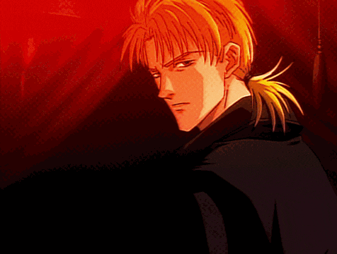 a man with a ponytail looks at the camera