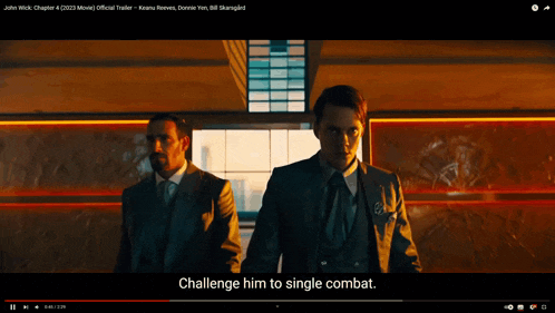 two men in suits are standing next to each other in a video that says challenge him to single combat
