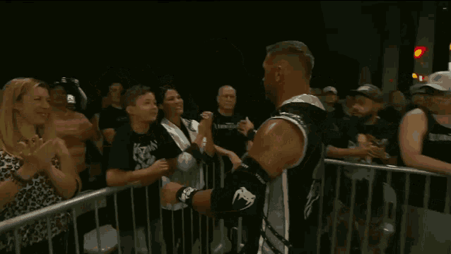 a young boy kisses a man on the cheek in front of a crowd
