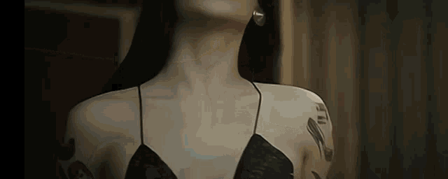 a close up of a woman 's neck and shoulder
