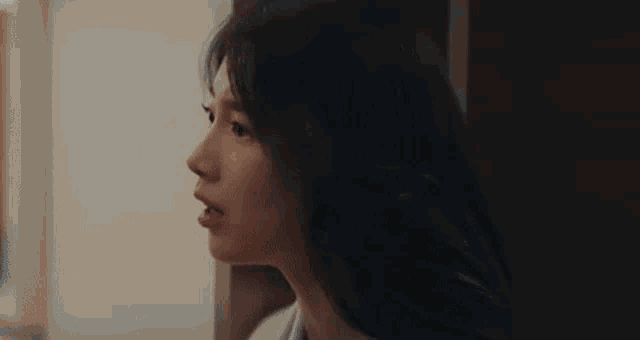 a close up of a woman 's face with a surprised expression on her face .