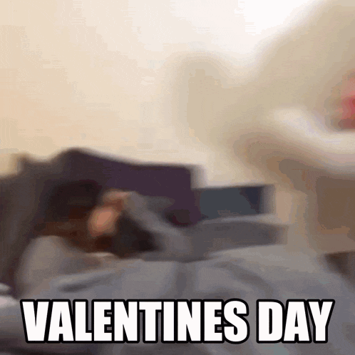 a blurry picture of a person laying on a bed with the words valentines day written on the bottom