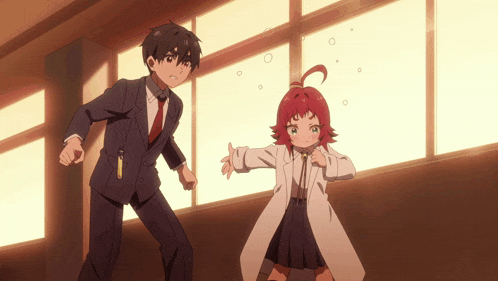a man in a suit and tie stands next to a girl with red hair