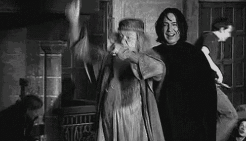 a man and a woman are standing next to each other in a room .