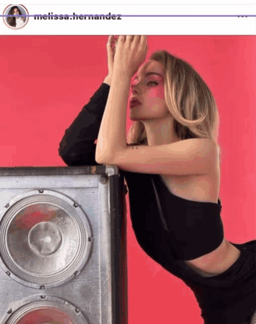 a picture of a woman leaning on a speaker with the name melissa.hernandez at the top