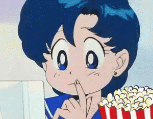 a cartoon girl with blue hair is eating popcorn while looking at a computer screen .