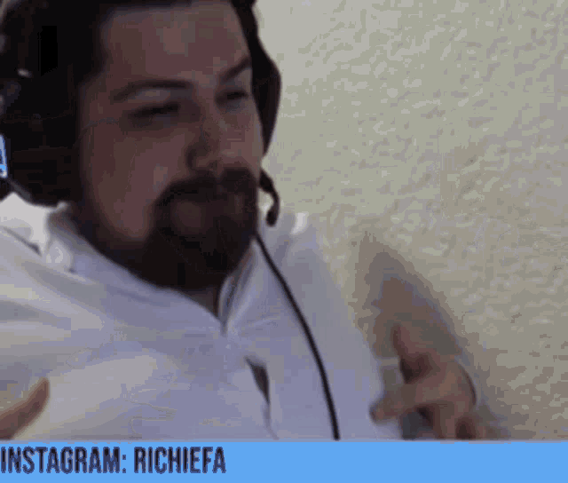 a man with a beard wearing headphones and a microphone