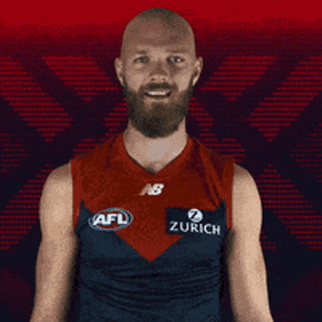 a bald man with a beard is wearing an afl shirt
