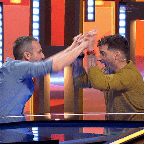 two men are giving each other a high five in front of a sign that says das sparkasse