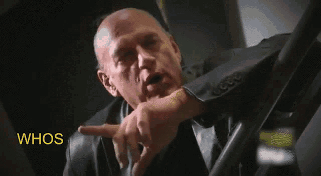 a bald man in a suit is asking whos the big kahuna in this deal