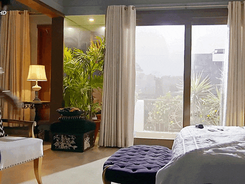 a bedroom with a large window and the word hd on the corner