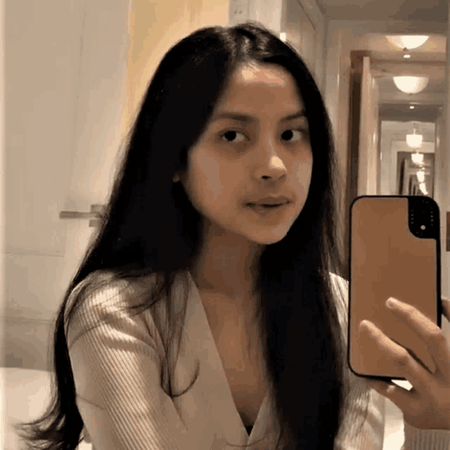 a woman taking a selfie with her phone