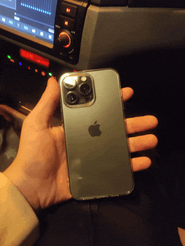 a person is holding an iphone in their hand