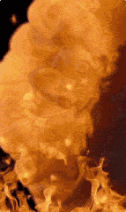 a close up of a fire explosion with smoke coming out of it