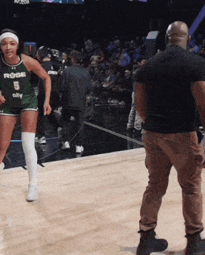 a female basketball player wearing a jersey that says rose on it