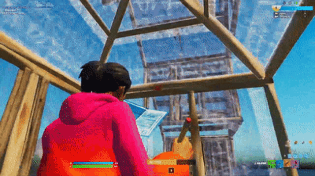 a man in a pink jacket is playing a video game