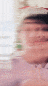 a blurry picture of a person 's face with a christmas tree in the background